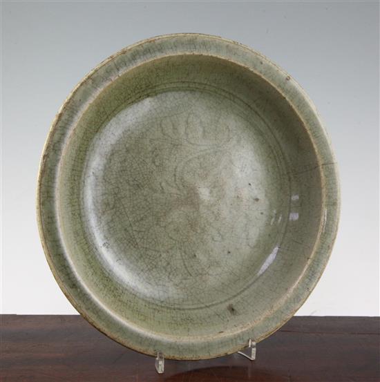 A Chinese Longquan celadon dish, 15th century, 30.5cm, rim crack and crazing to glaze